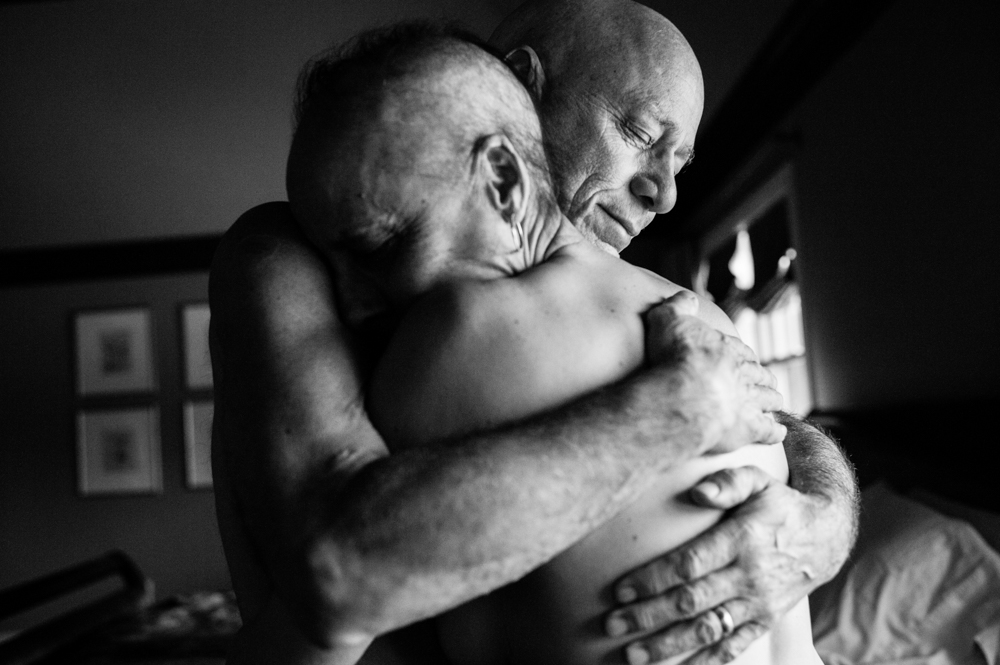 Howie and Laurel Borowick embrace in the bedroom of their home. In their thirty-four year marriage, they never could have imagined being diagnosed with stage-4 cancer at the same time. Chappaqua, New York. March 2013.