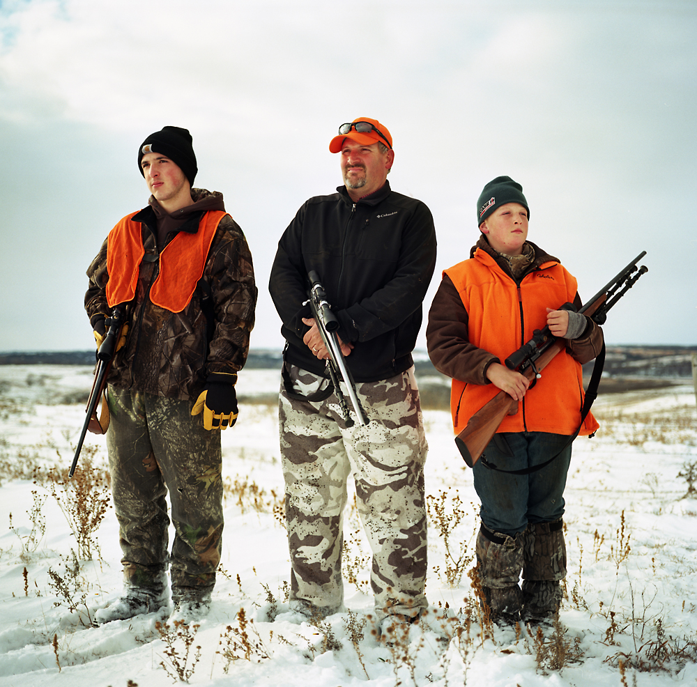 Jake Crumly, 15, left, father Ryan Crumly, and Zach Crumly hunt for deer on opening weekend on their family's property near Page, NE. The proposed Keystone XL would cut through their family's property.