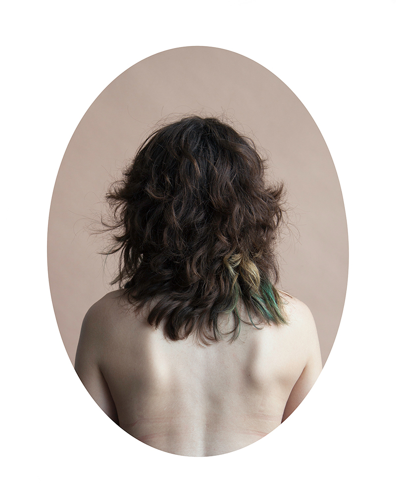 “a modern hair study” consists of portraits of young women photographed from behind.  By focusing on the back, the viewer is forced to contend with all of the peripheral things that make each woman unique.