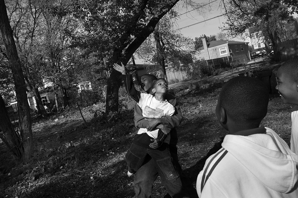Young boys continue to play in empty lots after the deaths of their neighbors, Starkeisha Reed, 14, and Siretha White, 10. Englewood, Chicago, 2006