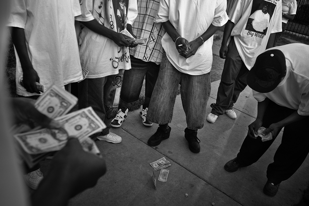 Young men pass time by playing dice on South Marshfield Avenue and West 69th Street. Englewood, Chicago, 2006