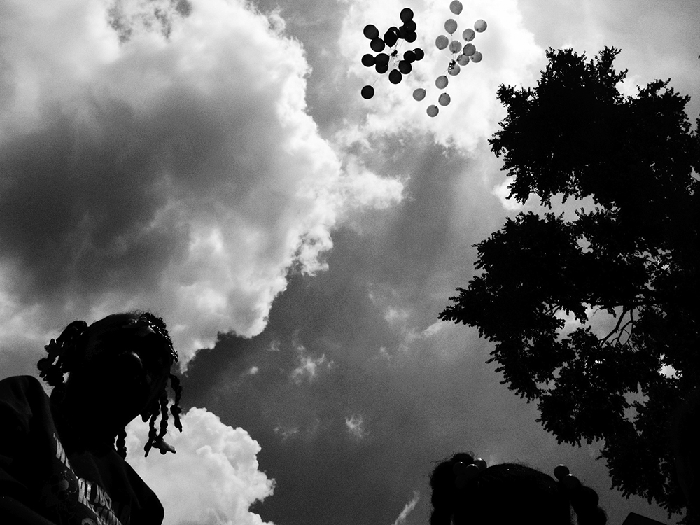 Balloons are released in memory of Siretha White and Starkeisha Reed during a block party on South Marshfield Avenue and West 69th Street. Englewood, Chicago, 2009
