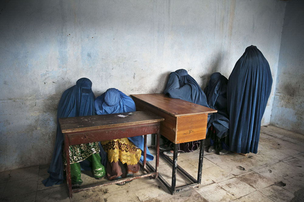 Kabul, April 5, 2014. Burqa-clad women wait to vote after a olling station runs out of ballots.