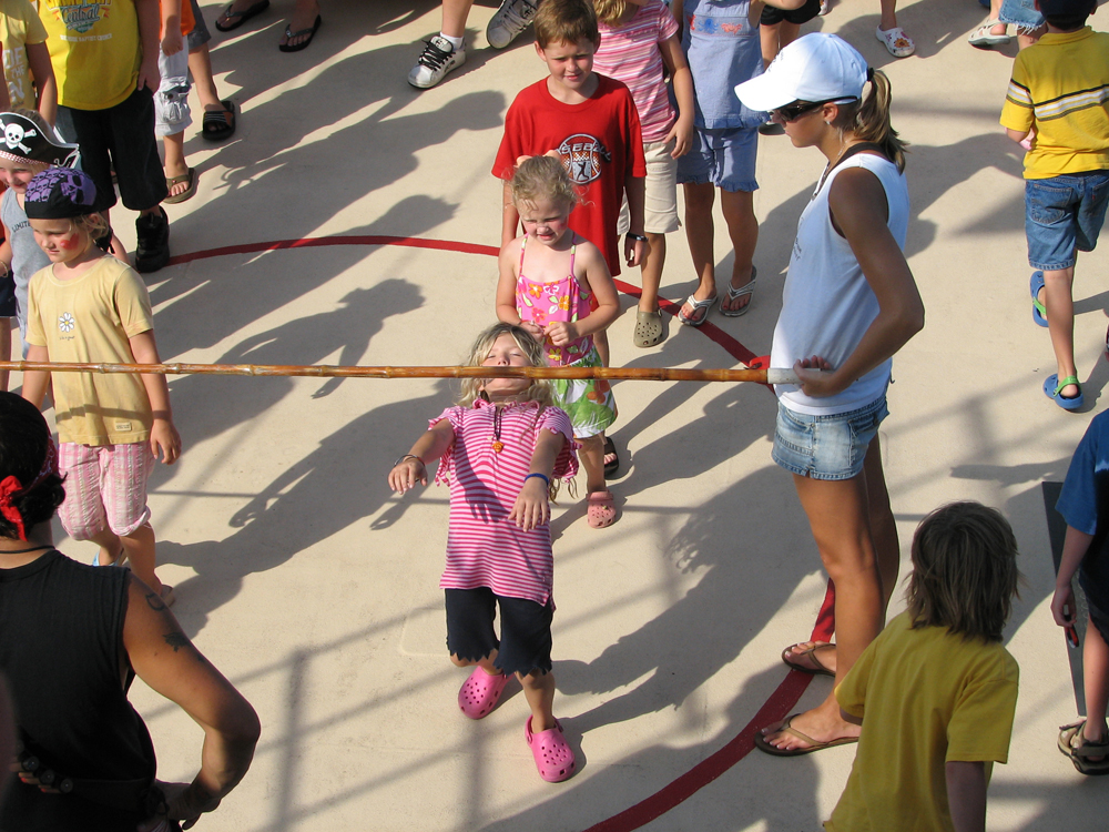 Color photo of children playing limbo taken in Panama City Beach, Florida.