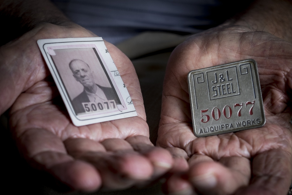 Pete Marovich, Sr., holds his father's Jones and Laughlin Steel Company ID card and badge on June 7, 2015 near Aliquippa Pa., USA. The company cut Tom Marovich's ID card in half upon his retirement after 37 years at the Aliquippa Works.