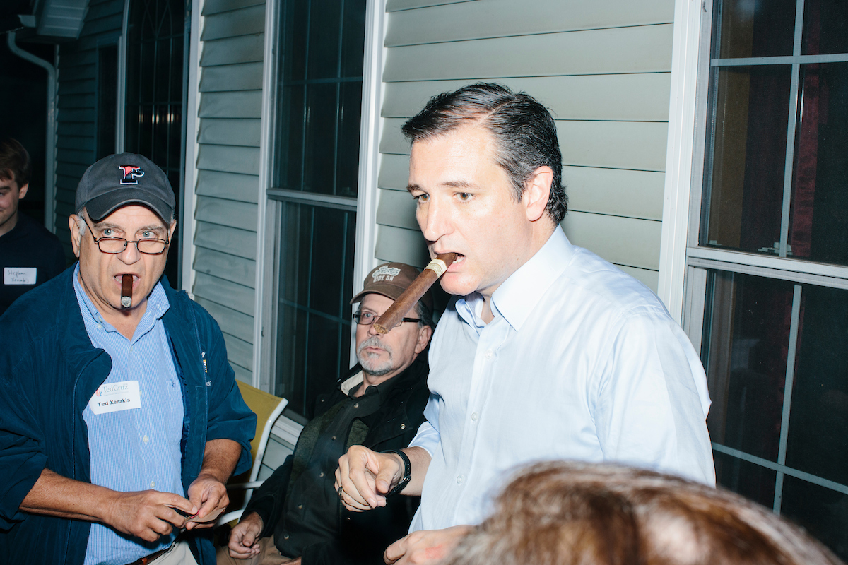 Texas senator and Republican presidential candidate Ted Cruz smokes a cigar after speaking at an event called "Smoke a cigar with Ted Cruz" at a house party at the home of Linda & Steven Goddu Salem, New Hampshire.