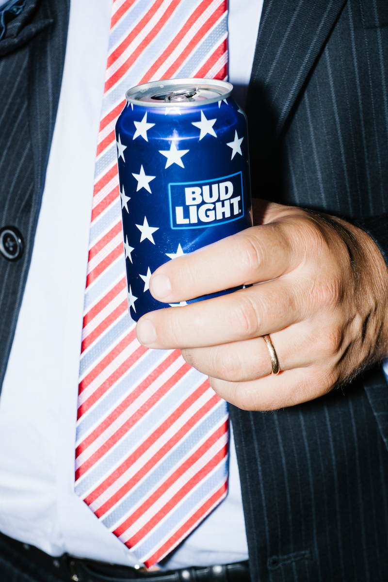 A man holds an American flag-themed can of Bud Light beer on the final day of the Democratic National Convention at the Wells Fargo Center in Philadelphia, Pennsylvania, on Thurs., July 28, 2016.