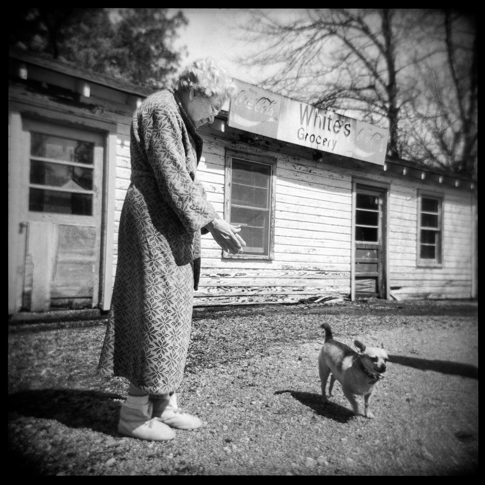 Mrs. White and her dog in front their now closed general store, Dogtown, Mississippi