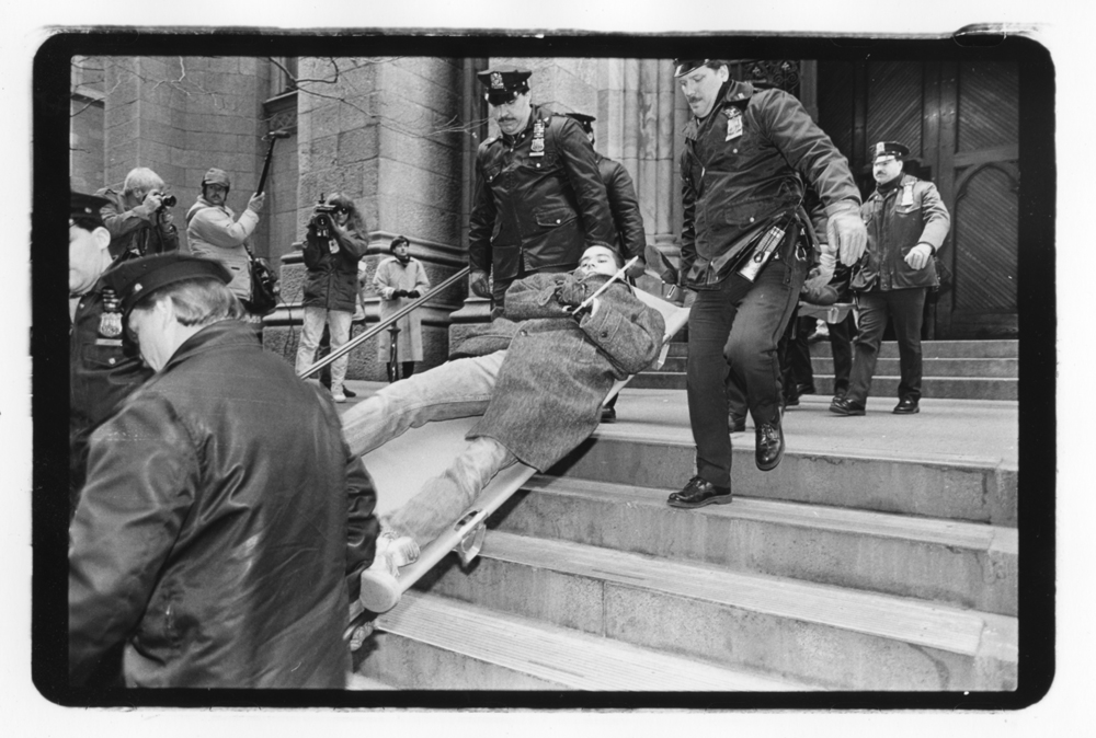 A protester is carried away during an ACT-UP Stop the Church direct action at St. Patrick’s Cathedral on December 10th, 1989.© Brian Palmer