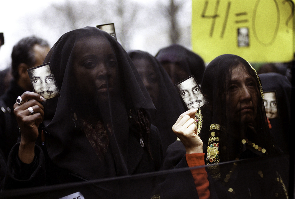 A group called “Women in Mourning and Outrage” hold up photographs of Amadou Diallo during a rally in front of the United Nations. The rally was held after the acquittal of four New York City police officers involved in the shooting of Mr. Diallo, who was unarmed. February 27, 2000.