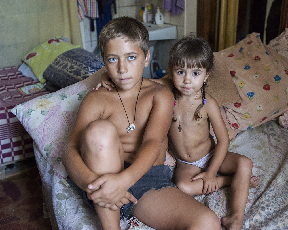 Danil, 12, and his younger sister have lived with their family for over a year in the government-assisted shelter Collective Center in Mariupol. "I miss my home, I miss my friends. My parents would like to go back but they're afraid because my sister is so small. I don't like it here, it's boring. There are no other children here, so I have no friends."