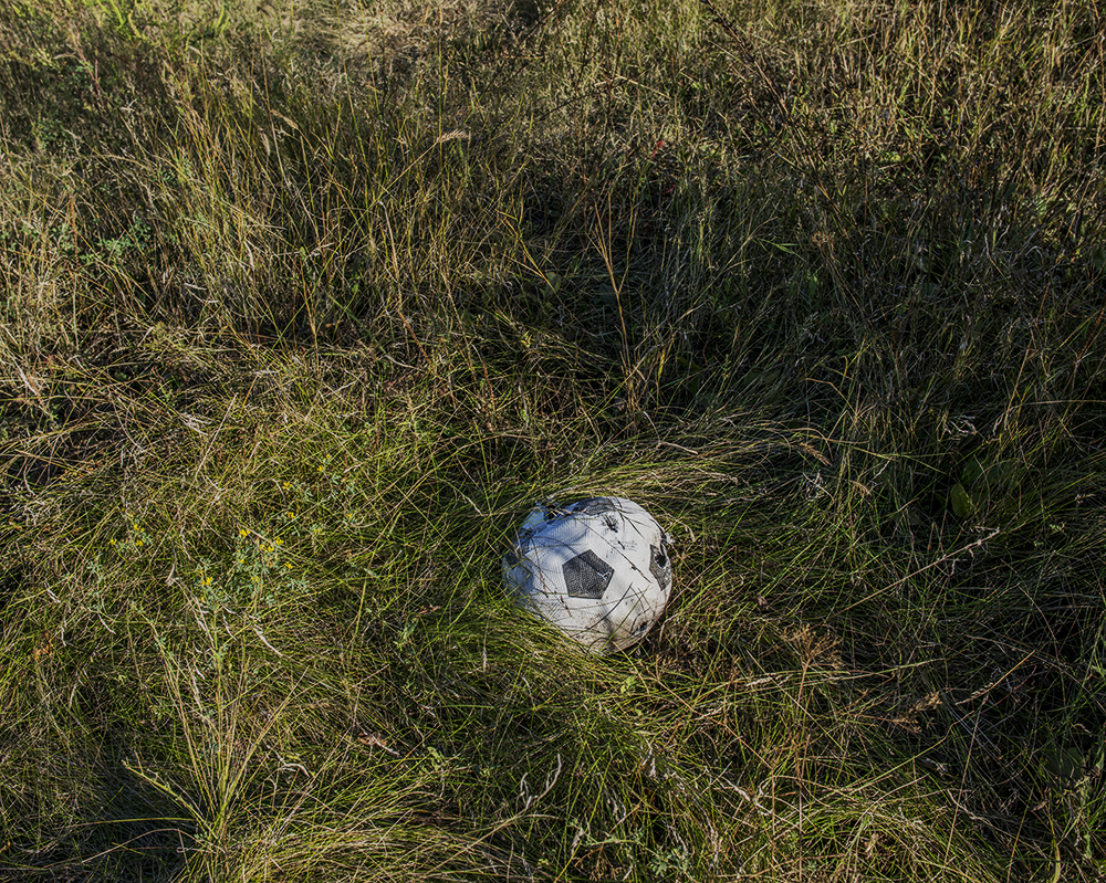 A soccer ball punctured by shrapnel in the village of Pisky. "Everybody wants to stop this war, everybody wants peace." -Giorgiy, 68, Anatol