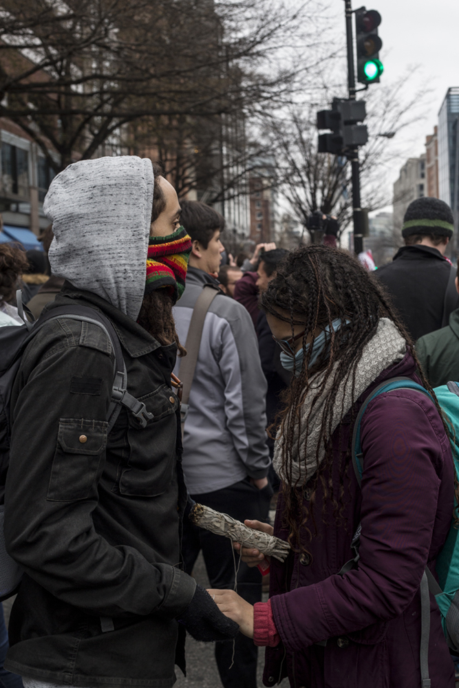 WASHINGTON DC: JANUARY 20, 2017: Two protesters hold hands during Donald Trump Inauguration Day Protests on January 20th 2017 in Washington DC.(photo by Benjamin C Tankersley)