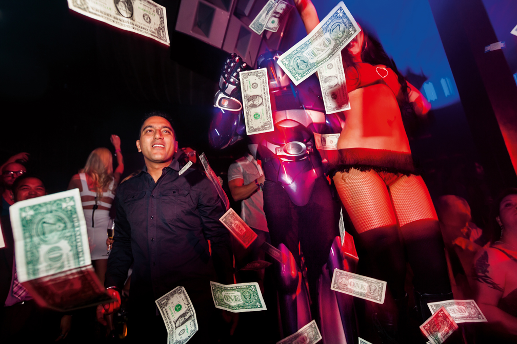 A selected VIP guest “makes it rain” with hundreds of one dollar bills on a sold-out Saturday night at Marquee Las Vegas.  The club uses this unique technique to set the mood and pump up the crowd.  Marquee relies heavily on pushing premium champagne and liquor bottle service to a clientele eager to spend money. The pairing of high-caliber DJs with the over-the-top extravagance of the club is part of what makes this club the highest grossing nightclub in America.