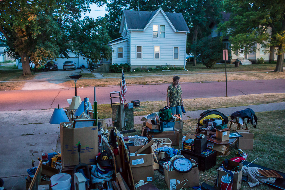 Lloyd Heslop looks at his belongings scattered in the yard after being evicted from his apartment on Monday, July 16, 2012 in Webster City, IA.