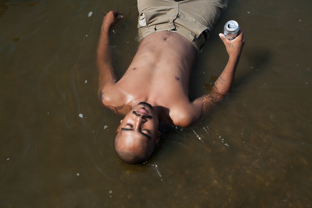 Alazar "Junior" Soto lies in the Des Moines River while tubing on Sunday, July 15, 2012 in Lehigh, IA.