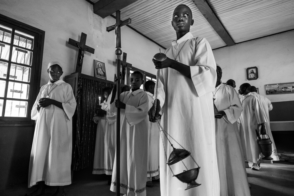 Alter servers are preparing for a traditional catholic mass celebration in Bangassou, held by Abbé Alain, one of the founding members of the mediation committee.