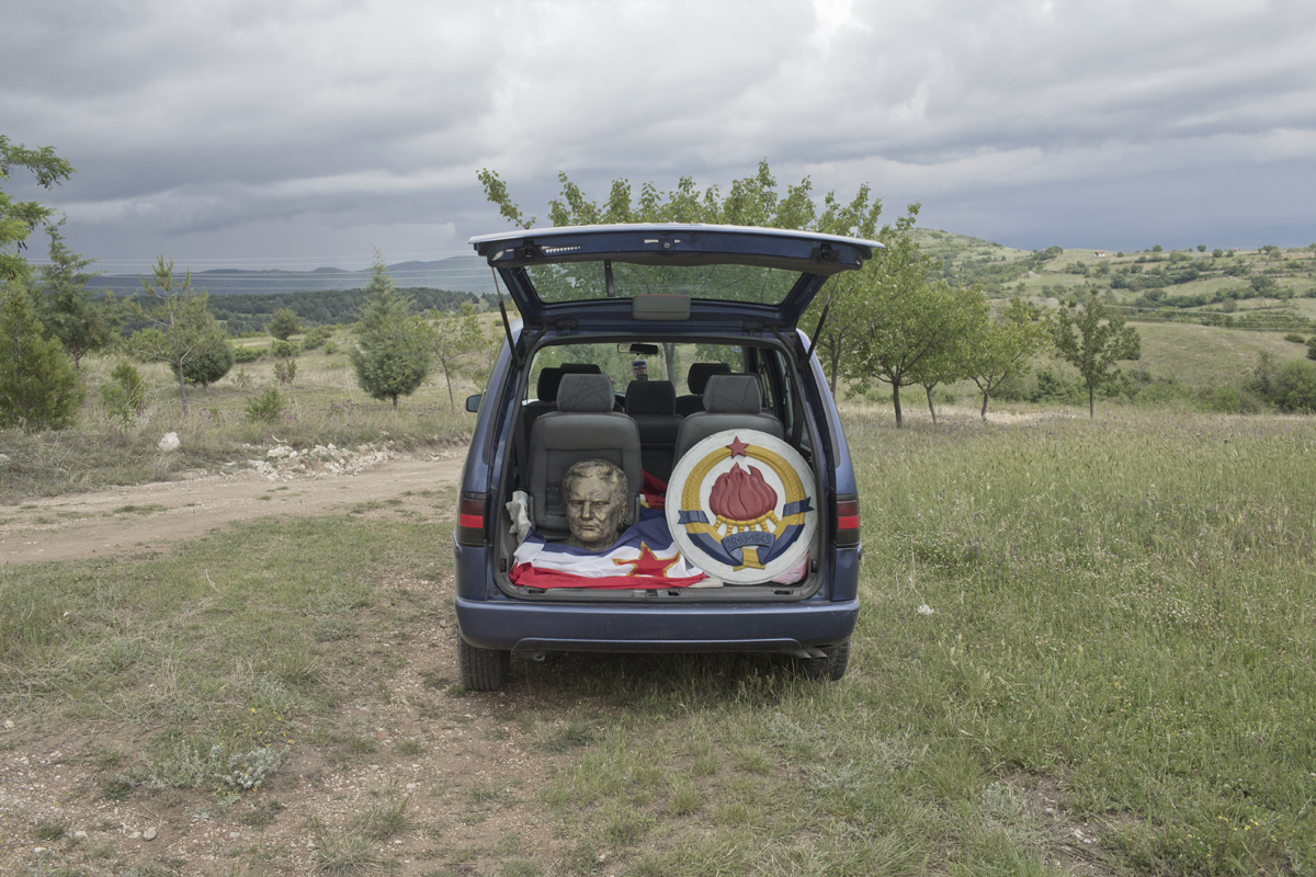 A bust depicting Josip Broz Tito, former Yugoslav leader, along with the Yugoslav flag and coat of arms, sits inside a boot of a car, Kocani, Macedonia, May 25, 2017. The items were used in a privately organized celebration of Tito's birthday in Kocani, eastern Macedonia.
