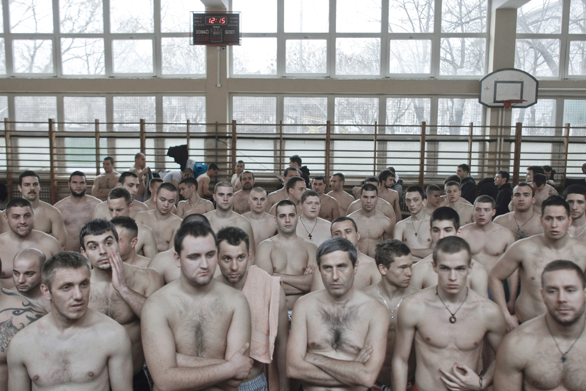 Participants in the Epiphany cross retrieval swimming race listen to a fiery motivational speech as they prepare to swim the winter waters of the Danube, Belgrade, Serbia, Jan. 19, 2014. Cross retrieval races and other Orthodox Christian religious traditions regained popularity in Serbia as nationalist and religious feelings surged after the breakup of Yugoslavia.