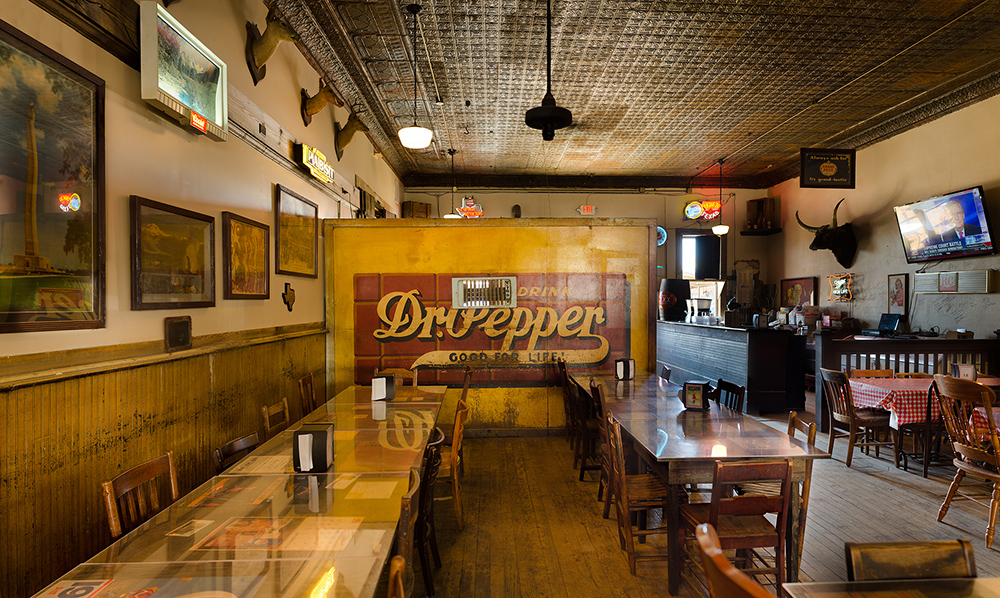 Segregation wall at Templin Saloon; Gonzales, Texas 2016 The wall was constructed in the early 20th Century and is decorated with an original pre-1929 Dr. Pepper logo. At the time of its construction (circa 1906) only Caucasian customers were allowed to sit in the front of the saloon. All Hispanic, Latino and African-American customers had to sit behind the wall. When the saloon was remodeled and re-opened in 2014 the wall, no longer used for its original purpose, was retained as a historical reminder. ©Rich Frishman ALL RIGHTS RESERVED