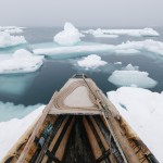 Traditional whaling is practiced in tune with the unpredictable weather of the Arctic. Wind has pushed floating ice near the shorefast ice and the whalers must wait until it shifts again, sometimes weeks later.