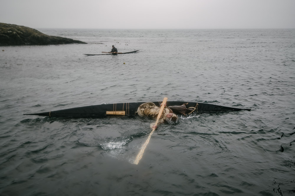 Kunuunnguaq Davidsen performs a Greenland kayak (qajaq) roll in the 2018 Greenlandic National Championships in Nuuk. Traditional kayak rolling was done to recover from capsizing during kayak-hunting. It has since evolved into a national sport with 37 increasingly difficult rolls.