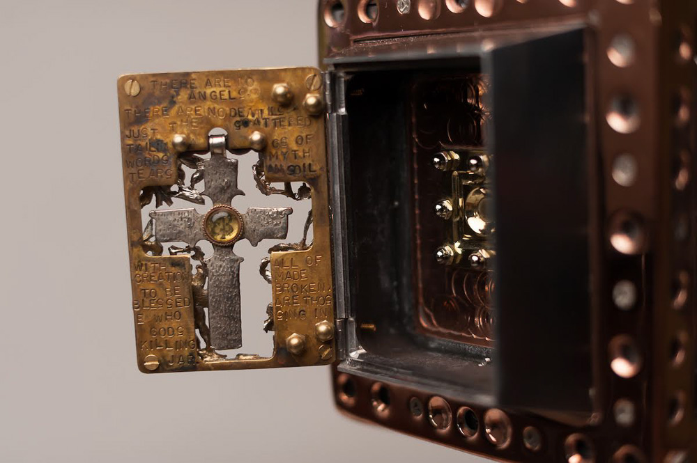 © Jade Beall, Front of "Us & Them" camera with aperture gate open showing the Eva Braun crucifix.