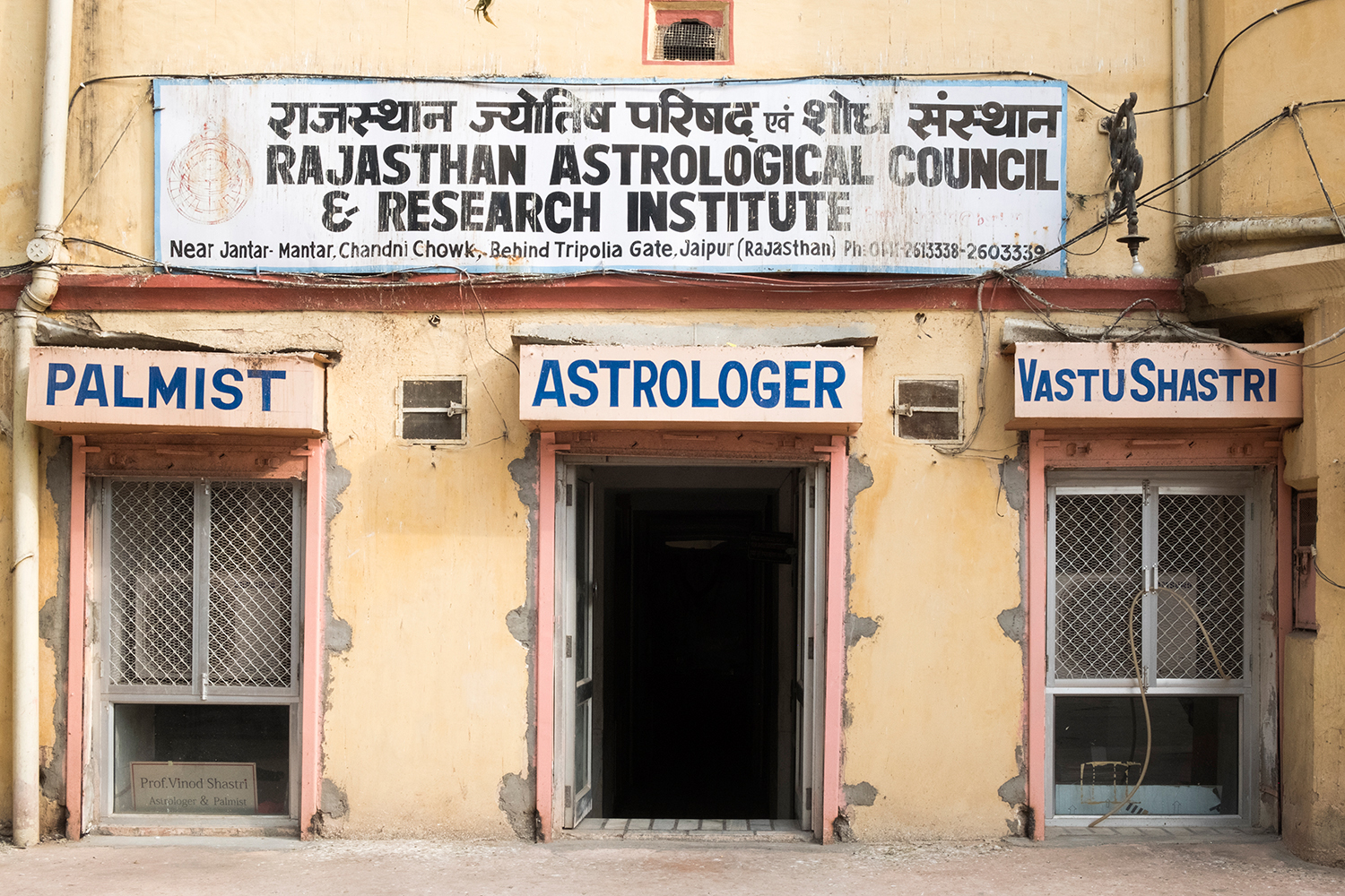 The Rajasthan Astrological Council and Research Institute, advertising a palm reading, astrology, and vastu shastri consultations, is located behind Jantar Mantar north of the old city in Jaipur, Rajasthan, India. Vastu Shastra is a traditional Hindu system of architecture and spatial geometry intended to integrate buildings with nature.