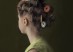 young girl with hair in thread spool rollers - green background