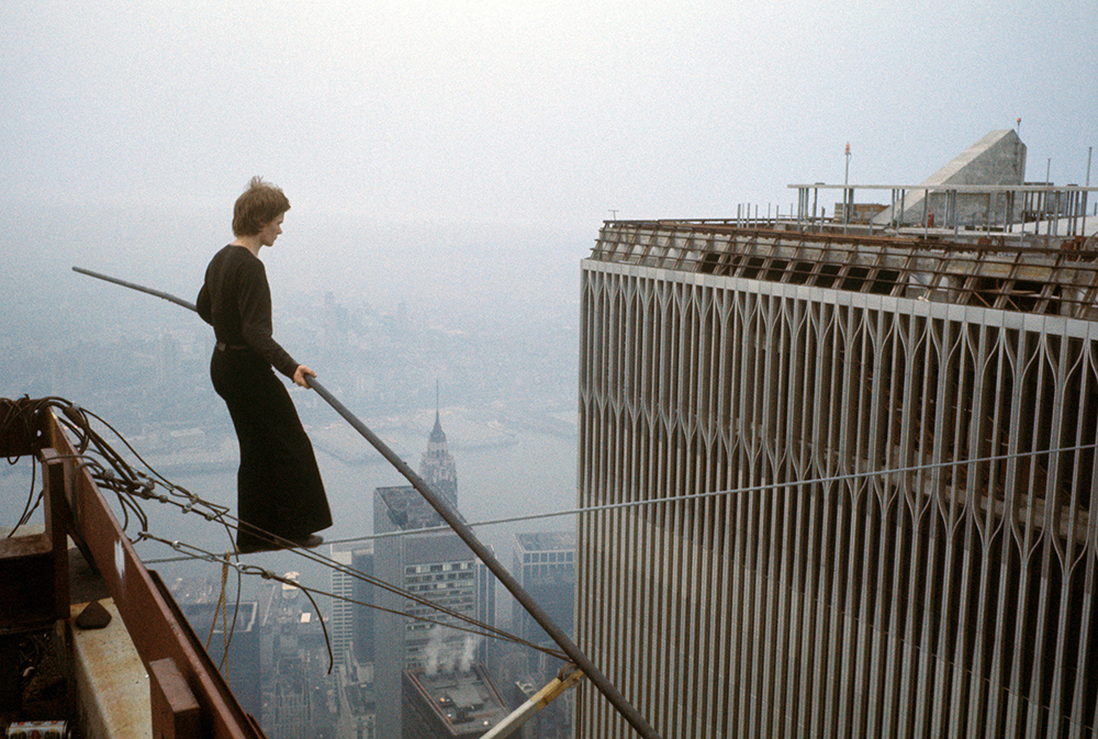EXCLUSIVE: August 7, 1974, New York, New York, United States: Philippe Petit, a young Frenchman artist tight rope walker, gave the most spectacular high-wire performance of all time by crossing the span between Towers I and II of the World Trade Center eight times in one hour. Petit and his team had illegally rigged their cable under the cover of night and he was arrested by the Port Authorities and charged with "attempt(ing) to cause public inconvenience," and trespassing. (Jean-Louis Blondeau/Polaris) ///  Philippe Petit walks on wire across the towers of the World Trade Center
