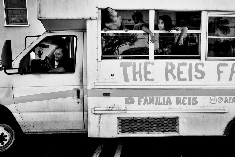 The family bus departs from the parking lot of a Mormon Church to find a good spot to spend the day. The family usually seeks day time parking near the beach or by a public park so the children can play freely outside.