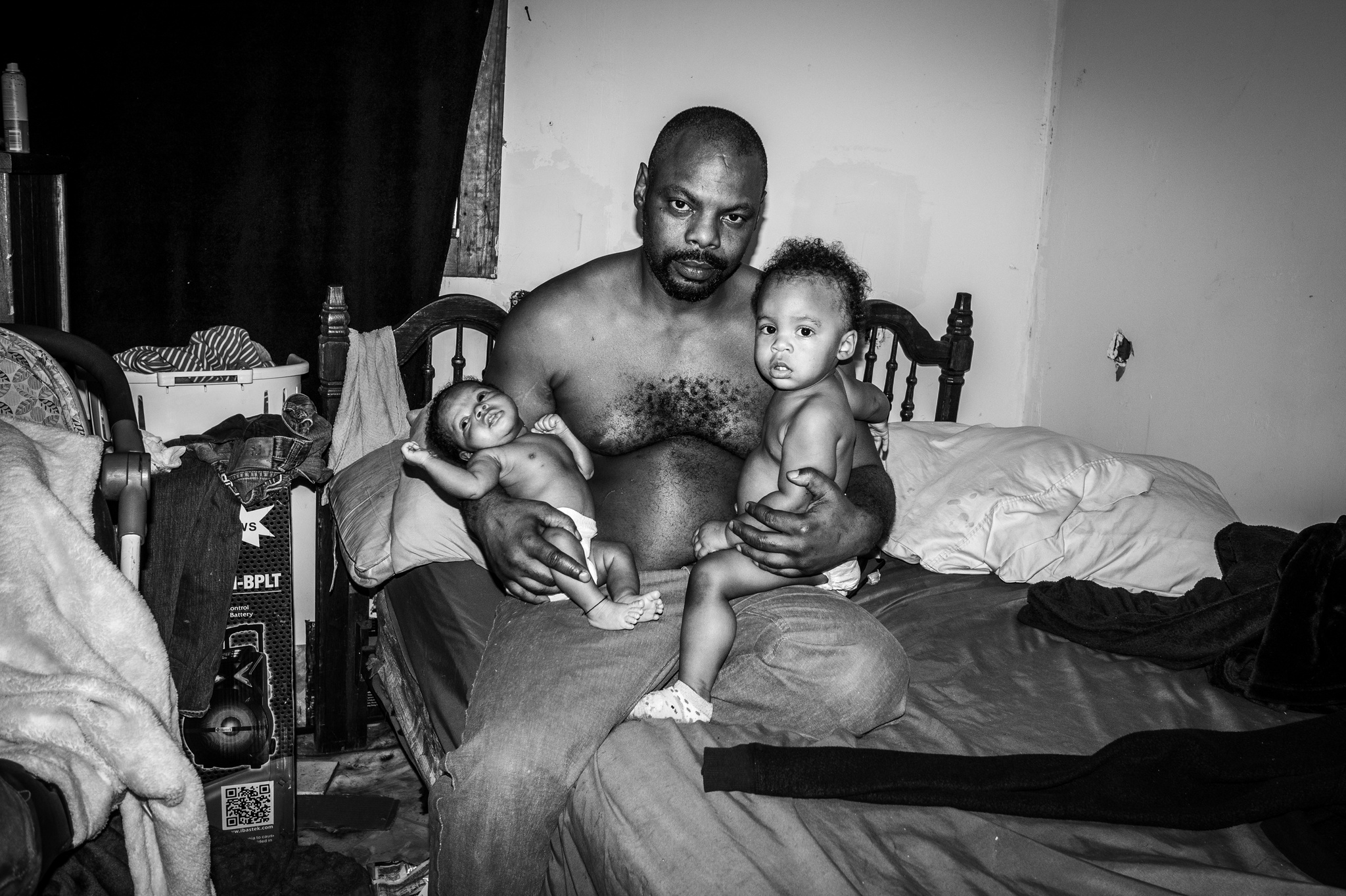 Chadley Johnson, aka "Cut Up," at home with his two children, Chad Love and Chastity. Scotlandville, Baton Rouge, Louisiana. December 2020.