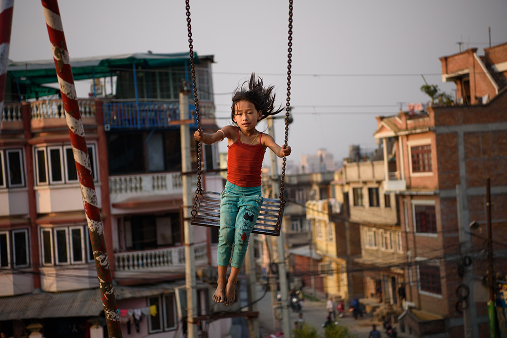 A girl plays in a public park in Patan. Thirty-seven percent of girls in Nepal marry before the age of 18, and ten percent are married by age 15. The minimum age of marriage under Nepali law is 20 years.