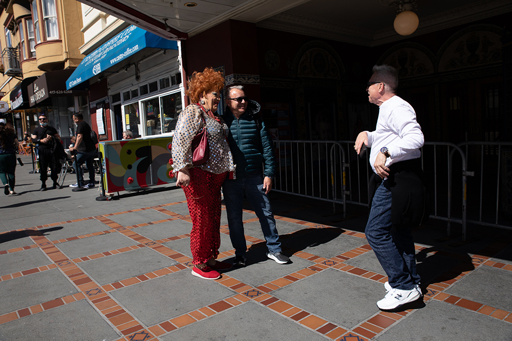 Olivia, who is a senior member of the Hot Boxxx Girls crew, stops to talk with some passersby in the Castro district who recognize her from one of her shows at Aunt Charlie’s and other venues in San Francisco on Saturday afternoon, May 21, 2022. Over the years, she has become known in the community partly because of her performances and in part for her extensive fundraising work supporting the LGBTQ community.