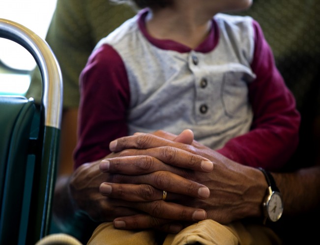 D- Rubin Sidhu crosses his hands as his 2-year-old son, Tej Mullins, sits on his lap while the family rides a rail car away from the San Francisco Bay on Sunday, May 22, 2022.