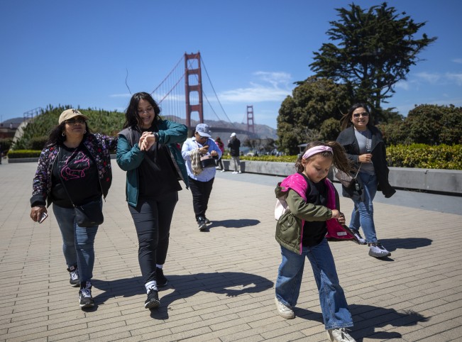 D- Aubrey Smith, 5, leads her family to the gift shop at the Golden Gate Bridge on Saturday, May 21, 2022 in San Francisco, California. The family traveled from Los Angeles because to be somewhere new that still feels like home.