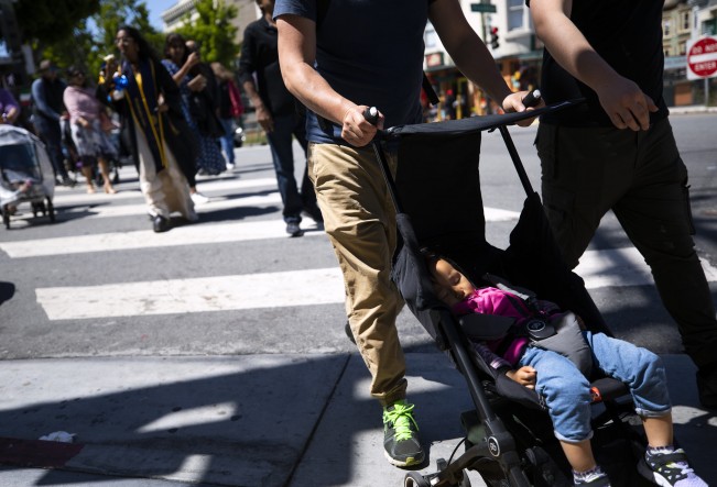 D- Maxine Moua, an 18-month-old Germany native, sleeps as her father pushes her stroller on Sunday, May 22, 2022 in San Francisco, California.