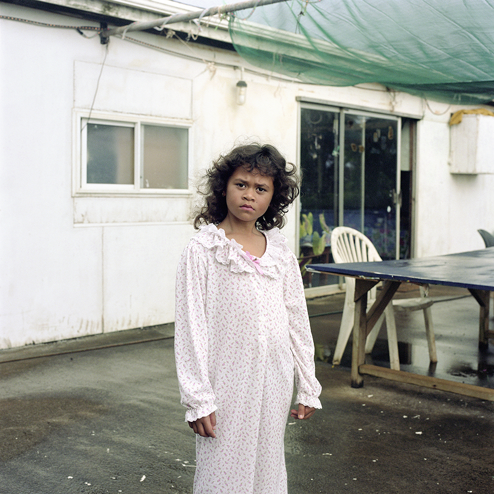 Cushana, aged six (b. 2009). Cushana was the only child living on Pitcairn Island during my stay. She is the youngest of Charlene Warren and Vaine Peu’s five children. Her elder siblings had all left for boarding school in Palmerston North, New Zealand – Pitcairn’s own school system ends at 15 – and Cushana now ran the roost.  Cushana is ferried to and from Pitcairn’s school, Pulau, daily by the island police officer, Brenda Christian (who has held the role since 2001), or by her mother, Charlene (who became the island’s mayor in 2019). Charlene was one of the original complainants in the trials, but later withdrew her statement when she returned to live on Pitcairn.  Cushana has a "safe adult" list, and is instructed to associate only with those included. On an island of just 42 (in 2015), Cushana’s contact list is limited. At no time is she allowed to wander unaccompanied, and she is never left alone with island men. Her childhood is very different to that of the older Pitcairners, who describe a youth with few rules and absolute freedom. But it seems that that their freedom had come at a price.  If Cushana’s world is limited by the ocean that encircles the island, her lifestyle is dictated by the apparent threat of her neighbours. When she grows up, she wants to travel to London, see snow, and meet the Queen.