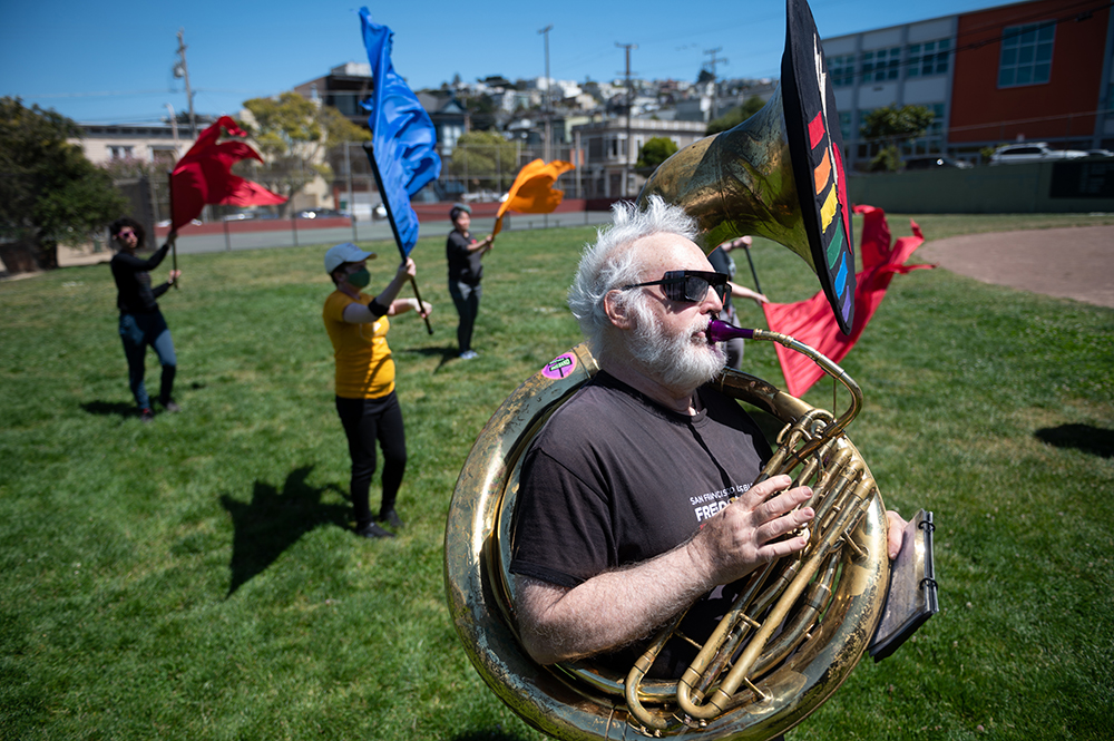 F - Marching with a sousaphone slung over his shoulder Michael Mehr plays California, Here I Come! during a band rehearsal at Rikki Streicher Field on Sunday, May 22, 2022 in San Francisco.  In 1984, Mehr rented a sousaphone to compete in a radio competition but after three payments the company went bankrupt. “No one came looking for me,” Mehr joked. He still plays the same brass instrument to this day, just now with a few more character scratches and bumps.