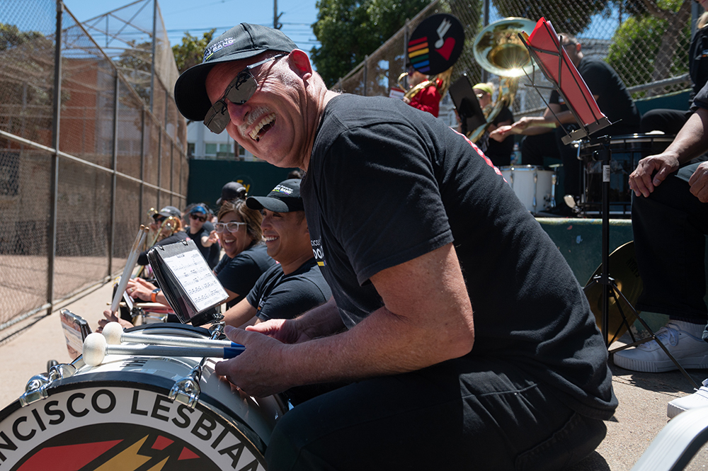 F - Gary Cozzi jokes with band members during a rehearsal at Rikki Streicher Field on Sunday, May 22, 2022 in San Francisco. The San Francisco Lesbian/Gay Freedom Band became the official band of the City of San Francisco in December, 2018. The motion by the city council to recognize the group was unanimous and signed into law by the mayor immediately.