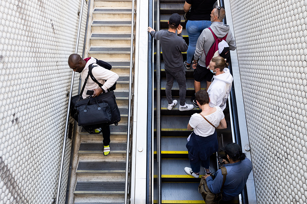 A: People travel up an escalator and down a flight of stairs at the Montgomery Street subway station. Beneath the streets, the subway connects people across the San Francisco area.