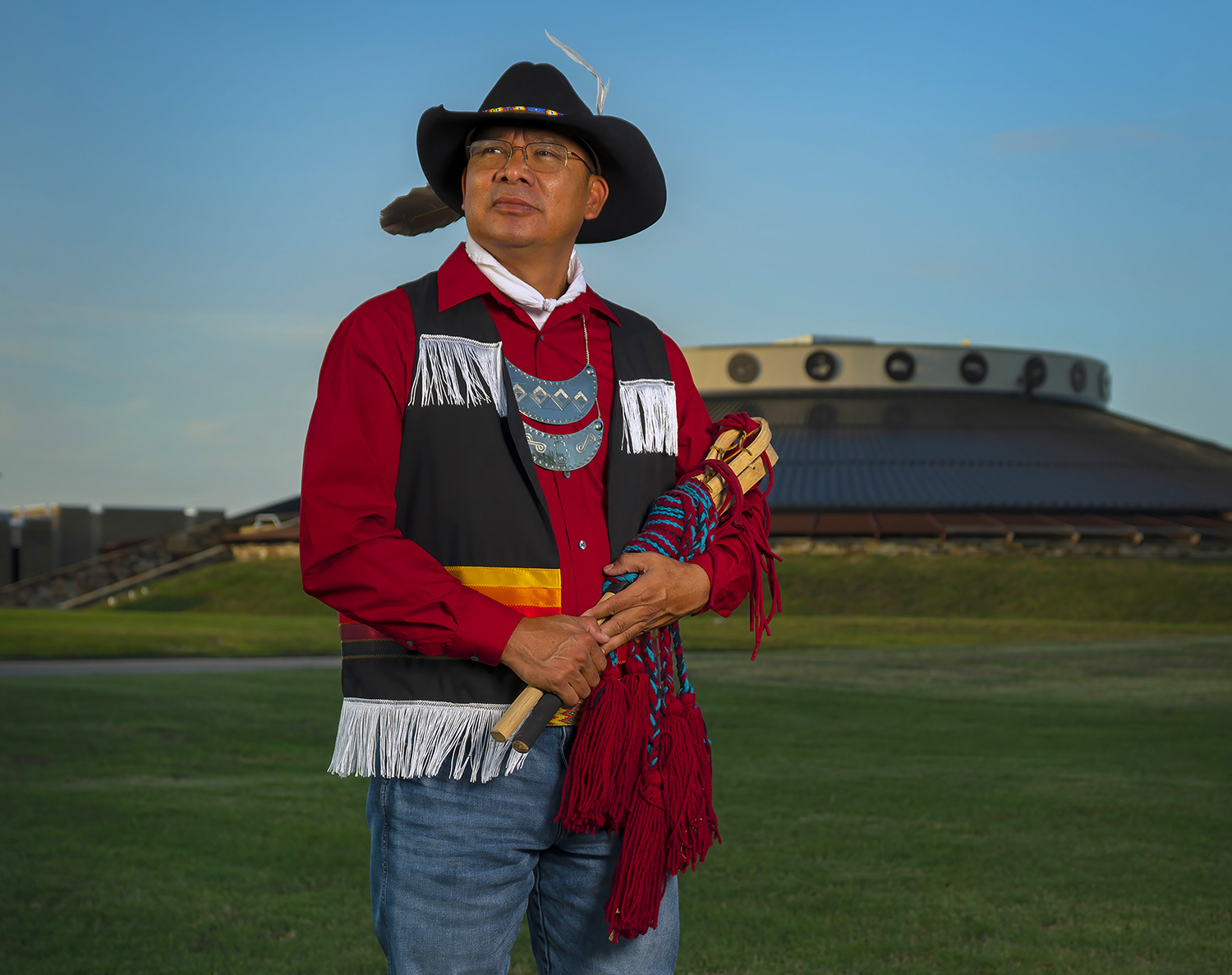 Portrait of Galen Cloud, Muscogee Creek tribal member and councilman holding a pair of ballsticks.