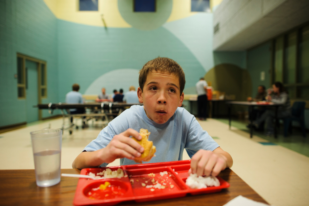Vinny, 13, sits in the cafeteria and eats his first meal at the Bernalillo County Detention Center in Albuquerque, New Mexico, 2012.