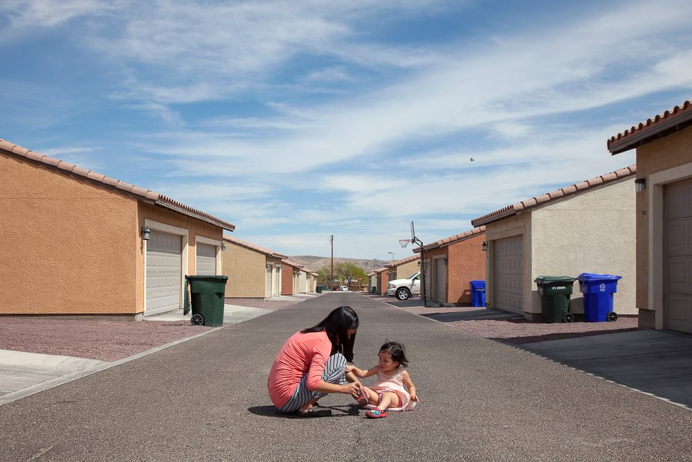 Jiyeong Laue cares for her daughter, Serenity, behind their home in 2014 in Fort Irwin, California