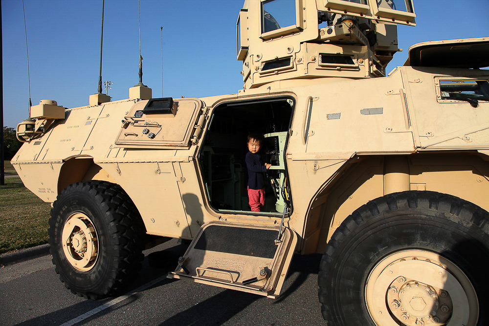 My son, Teo Principe, climbs in a 1117 Armored Security Vehicle during a family day visit to Fort Stewart, Georgia on November 15, 2016.