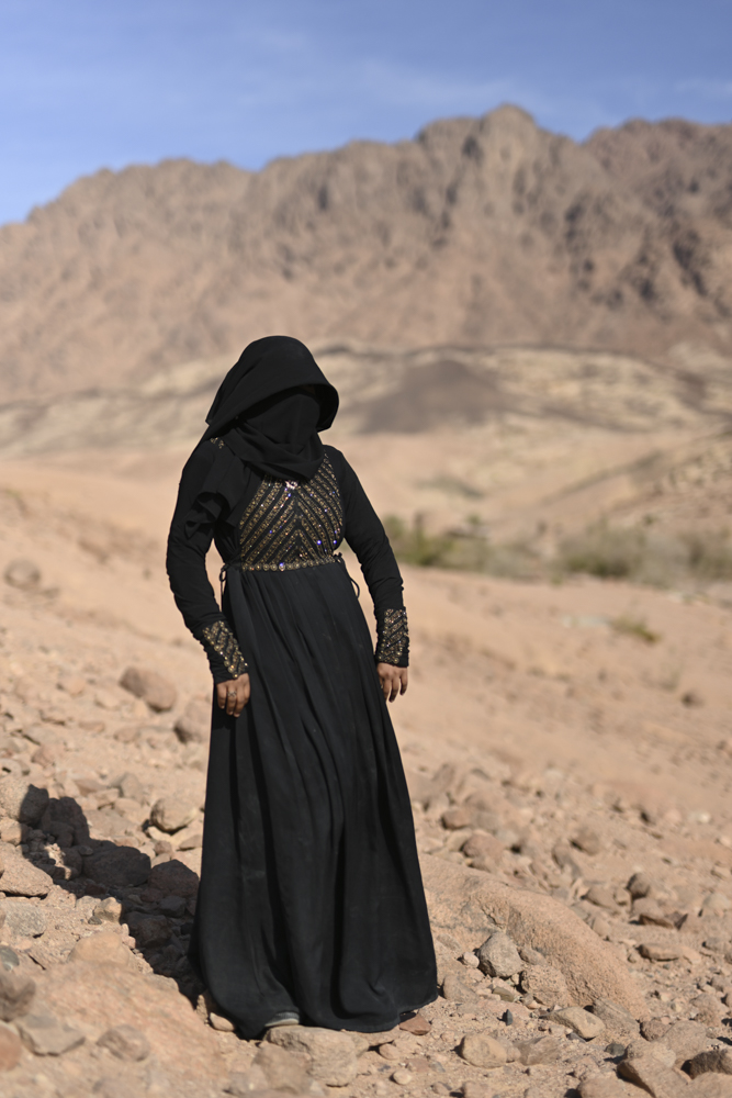 Hoda (23) from St. Catherine city stands on the edge of a hill looking over Gharba Valley. April 2019.