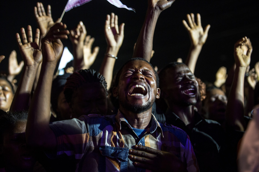 Attendees cheer during Invasion Evangelique event lead by prophet Jacques Neema Sikatenda in   Kinshasa, Democratic Republic of Congo.