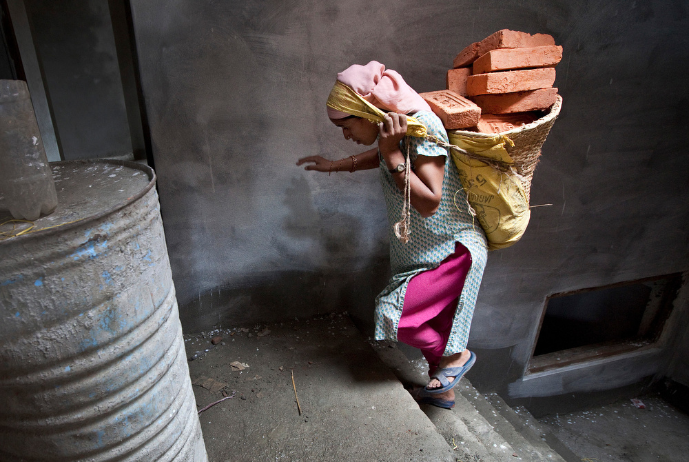 Evicted from her home by in-laws for not giving birth to a son, Laxmi KC, 30, is a mother of four who grew up in a rural area of Nepal. To take care of her family, she works predominantly as a construction worker. She carries heavy loads of sand or bricks up to the top floor of high story buildings.