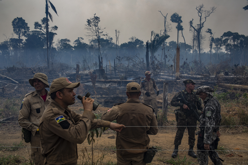 RIO PARDO, RONDONIA, BRAZIL: SEPTEBMER 2019: Team of brigade members of Ibama (Brazilian Institute of the Environment) work to combat a burning of a farm that expanded to the Amazon rainforest area near the city of Rio Pardo. Residents of the city were sued after setting fire to several environmental preservation areas belonging to the Bom Futuro National Forest, creating a climate of animosity between the local population and firefighters. The Brazilian army accompanies the combatant teams to ensure their safety in forest raids against possible attacks by the local population. CREDIT: Victor Moriyama for The New York Times