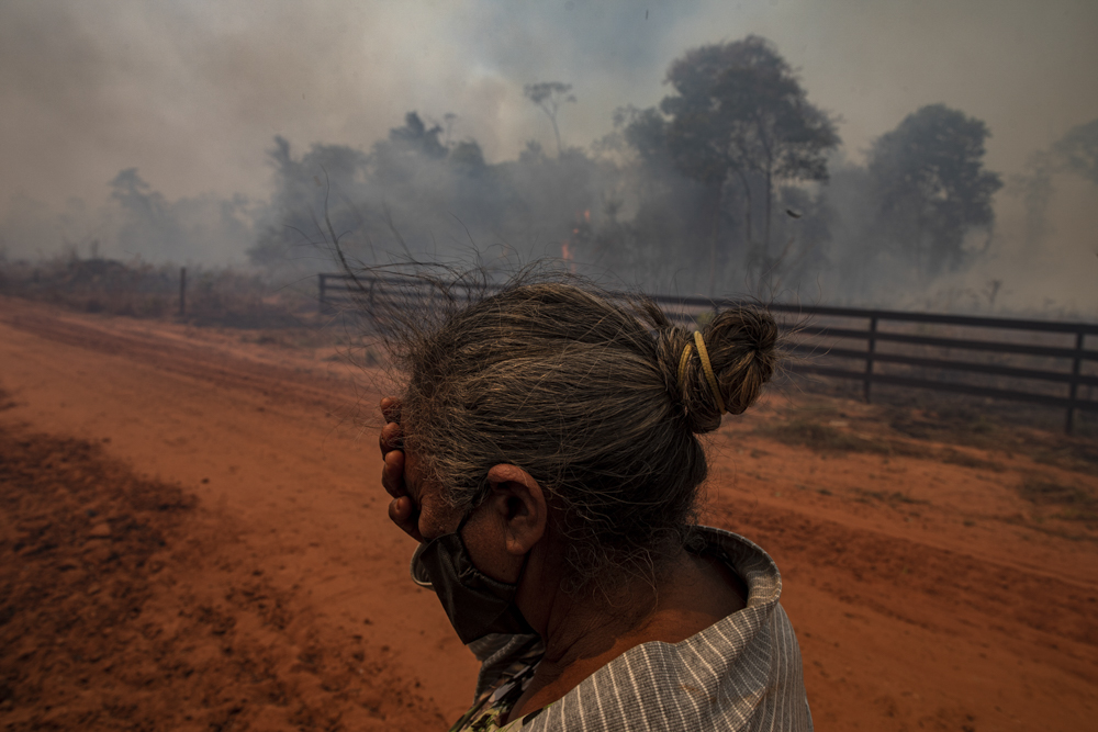 CLAUDIA, MATO GROSSO STATE, BRAZIL: AUGUST 2020:Members of the rural settlement 12 de Outubro in the city of Cláudia in the state of Mato Grosso try to put out the fire from an illegal burning in an Environmental Reserve area in the Amazon rainforest. Fire season in the Amazon biome during an expedition by the Rainforest Foundation to monitor the relationship between soy production in Brazil and its relationship with the deforestation of the Cerrado and Amazonia biomes. CREDIT: Victor Moriyama for Rainforest Foundation